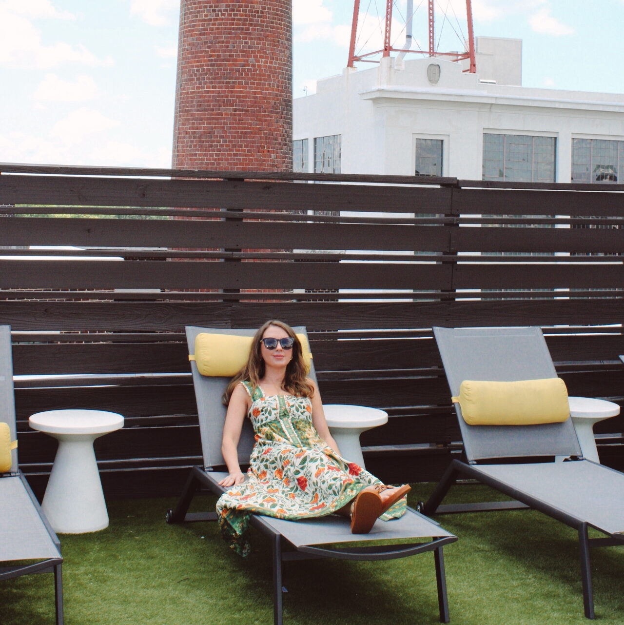 Amelia sits on a rooftop terrace